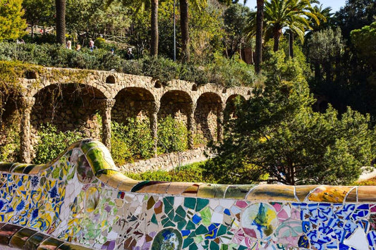 Mosaic bench and towers of Park Güell in Barcelona, designed by Gaudí